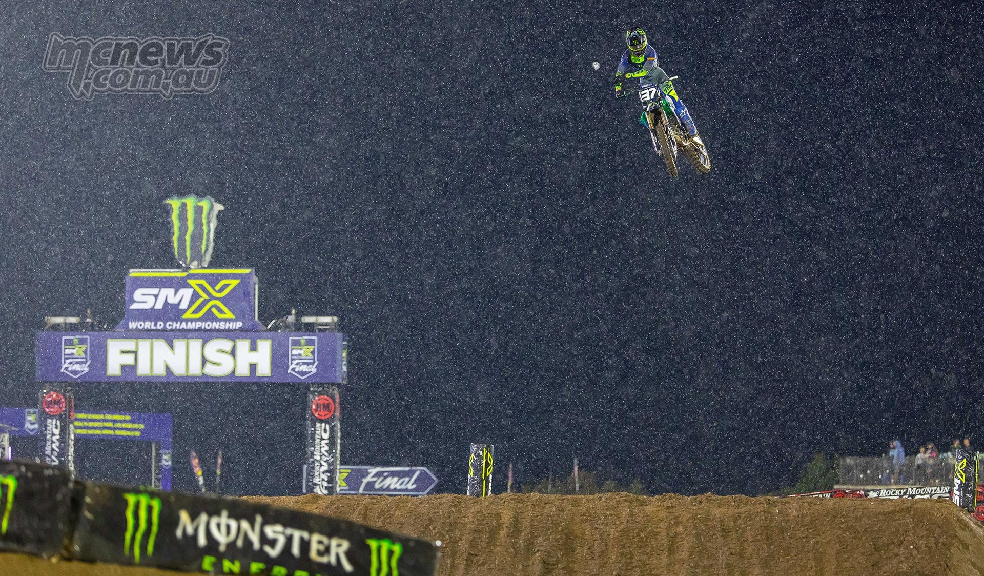Cole Davies jumps his Yamaha past the chequered flag under the lights.
