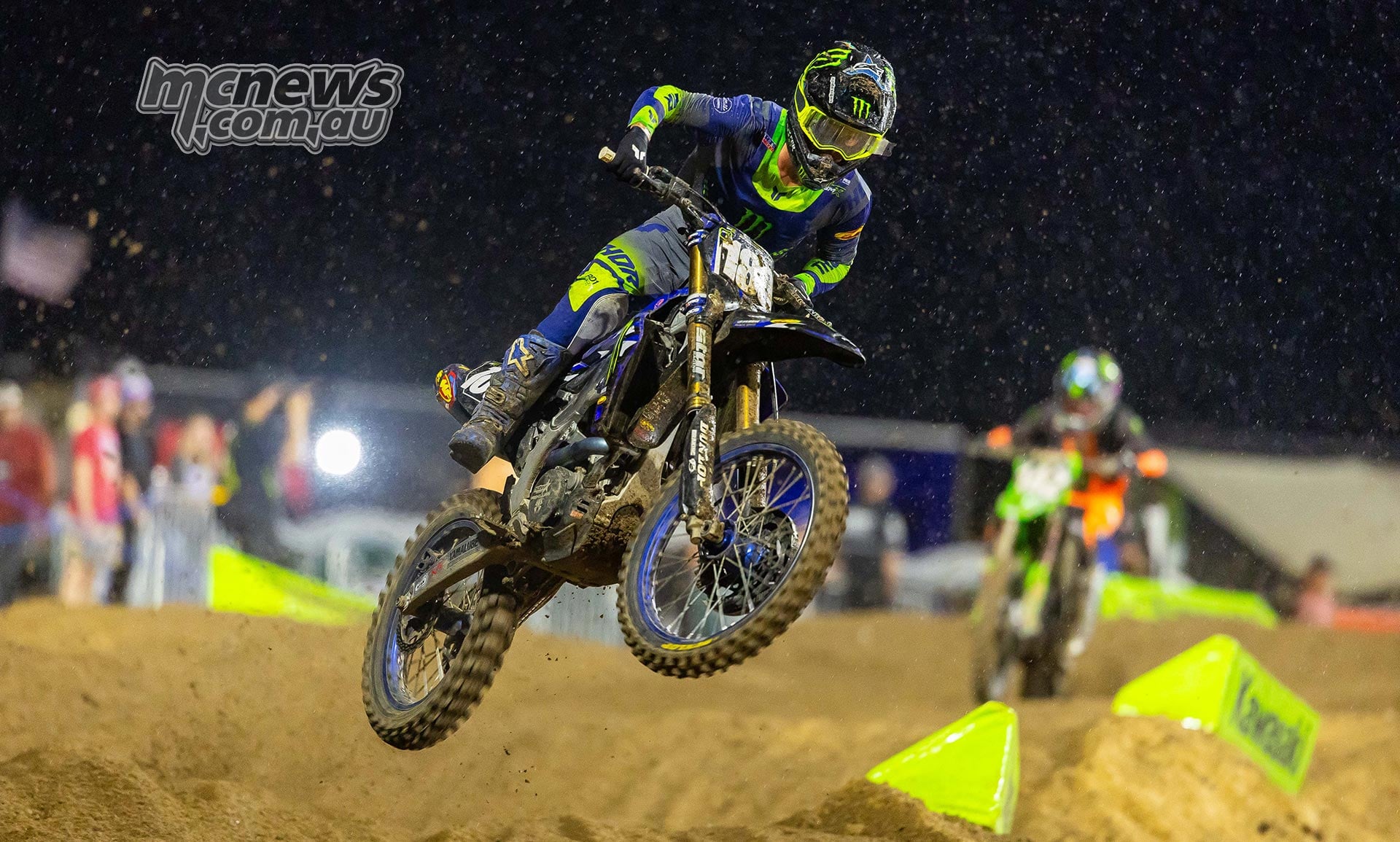 Landen Gordon jumps his number 180 Yamaha under the lights in the rain.