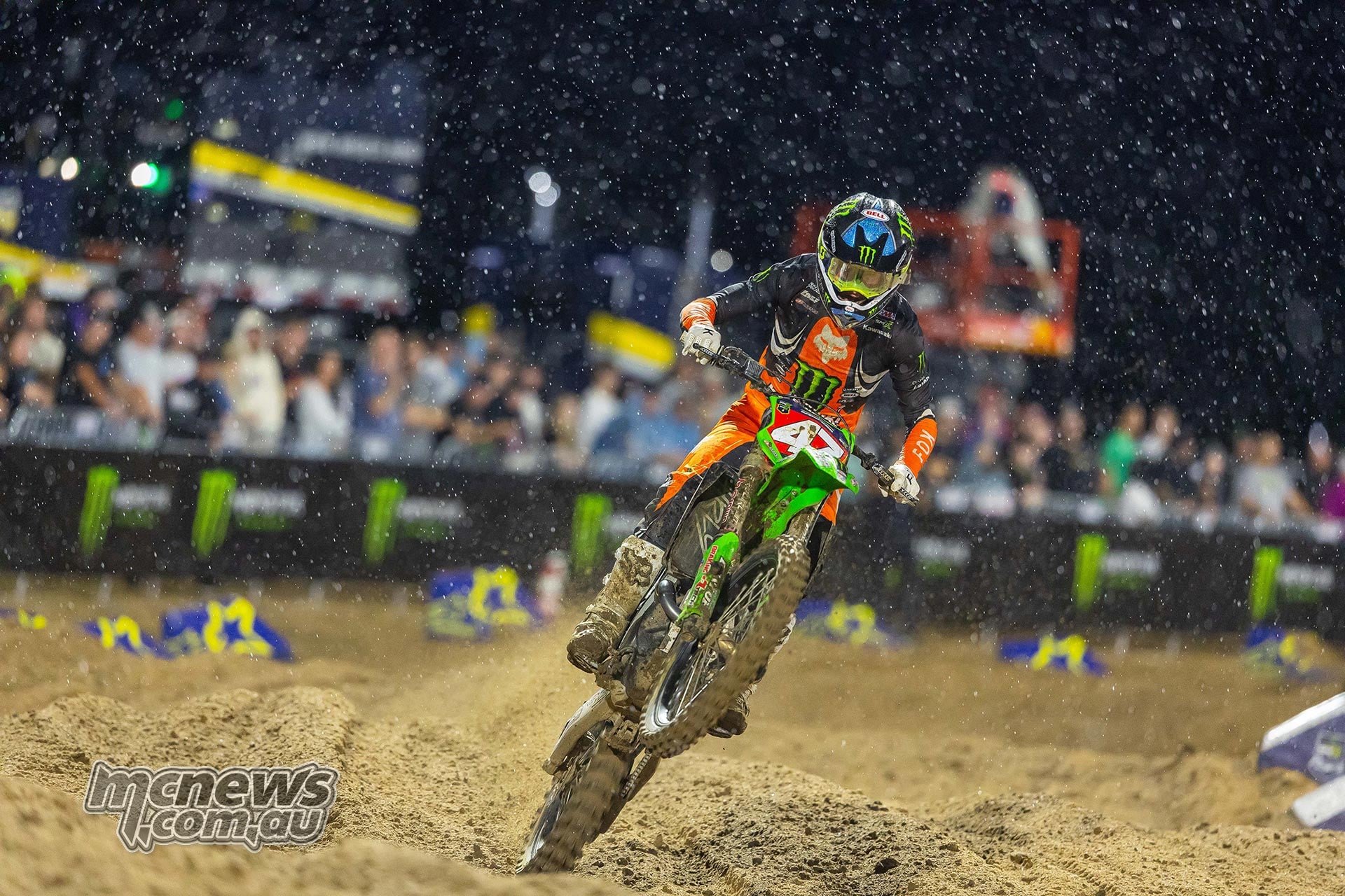 Levi Kitchen corners his Kawasaki under the lights as rain falls.