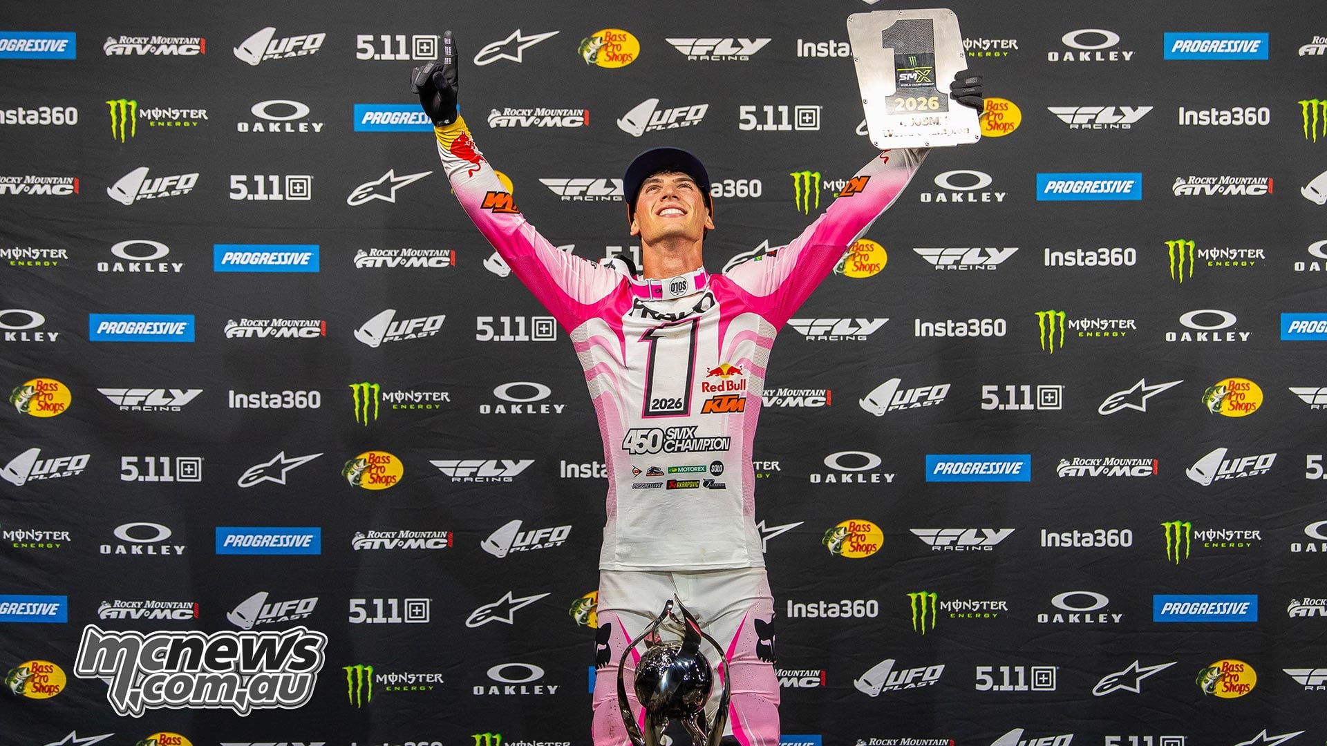 Jorge Prado raises the 450 SMX championship trophy and number-one plate.