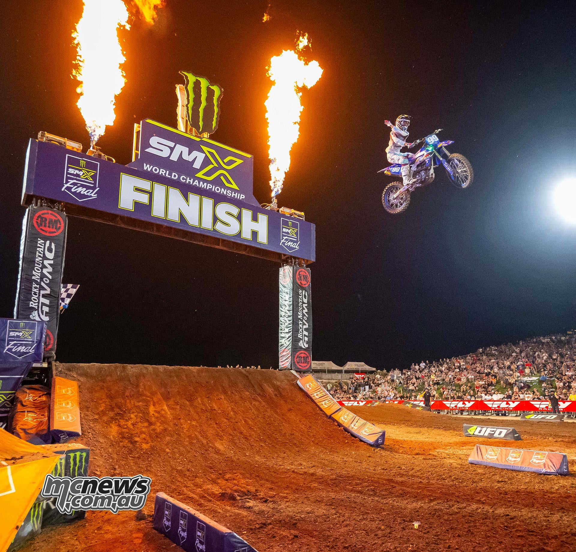 Lachlan Turner jumps her Yamaha across the finish line between pyrotechnics.