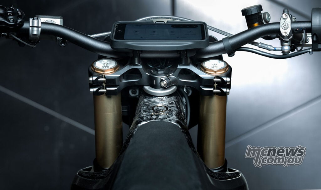 Rider’s view of the Stark VARG SM Sköll’s Arkenstone display, handlebar, black upper triple clamp and fork adjusters.