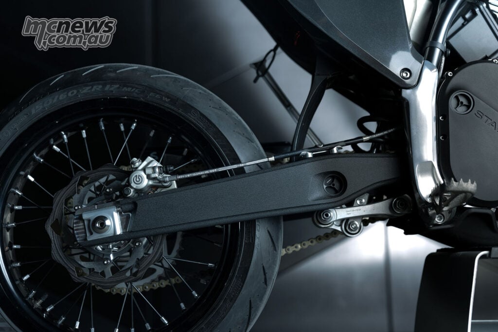 Close-up of the Stark VARG SM Sköll’s black swingarm, spoked rear wheel, Brembo caliper and rear brake disc.