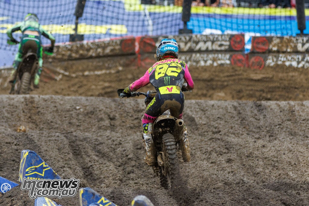 Rear view of Caden Dudney, number 82, riding his Yamaha through a muddy rut during 250SMX Race One at Columbus.