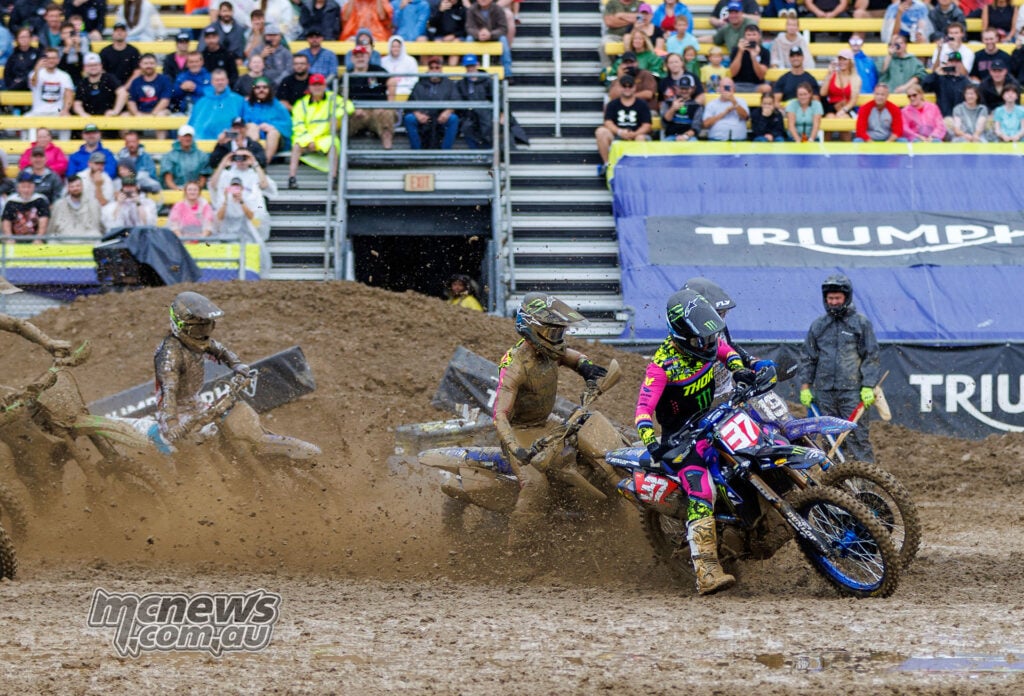 Cole Davies on the number 37 Yamaha leads a group of mud-covered riders through a wet corner at the Columbus SMX Playoff.