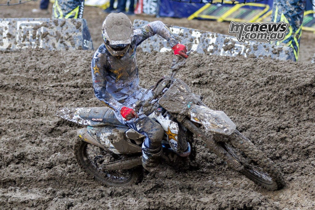 Daxton Bennick leans his mud-covered Husqvarna through a rutted corner during the closing stages of Race Two at Columbus.