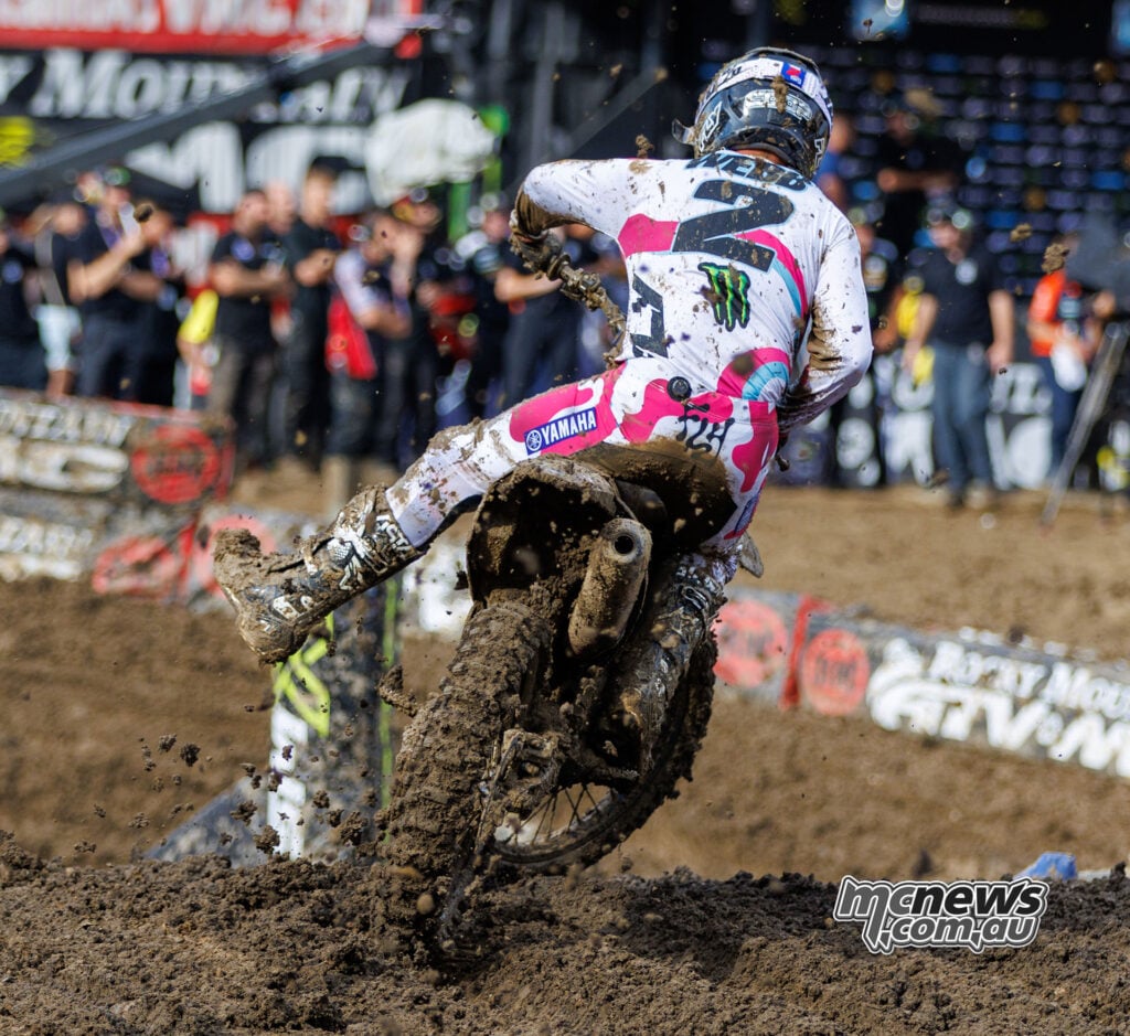 Cooper Webb lifts his Yamaha over a muddy rise with his left leg extended during 450 race two.
