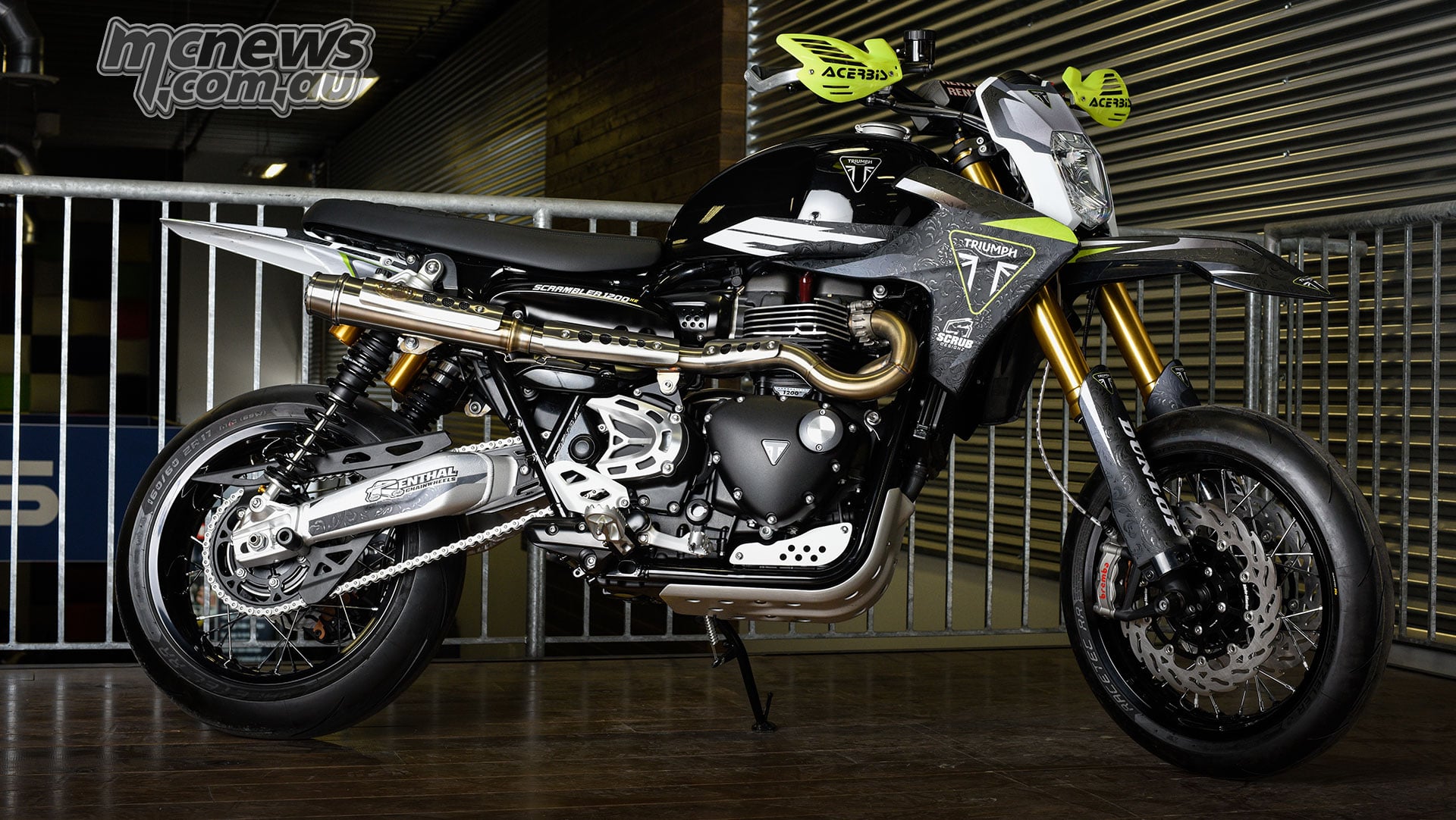 Black and silver Triumph Scrambler 1200 XE supermoto by Motos Illimitées, with 17-inch wheels and bright yellow handguards.