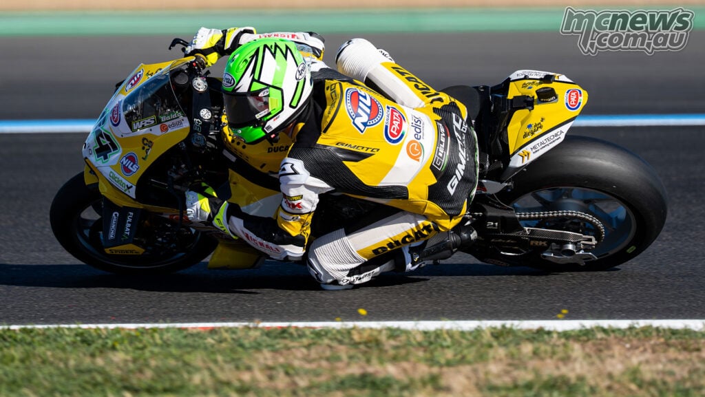 Lorenzo Baldassarri at full lean on the yellow number 34 Team GoEleven Ducati at Magny-Cours.