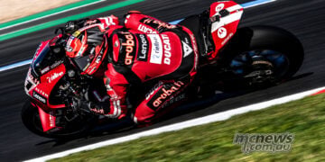 Nicolo Bulega leans the red number 11 Aruba.it Racing Ducati through a corner during Friday practice at Magny-Cours.