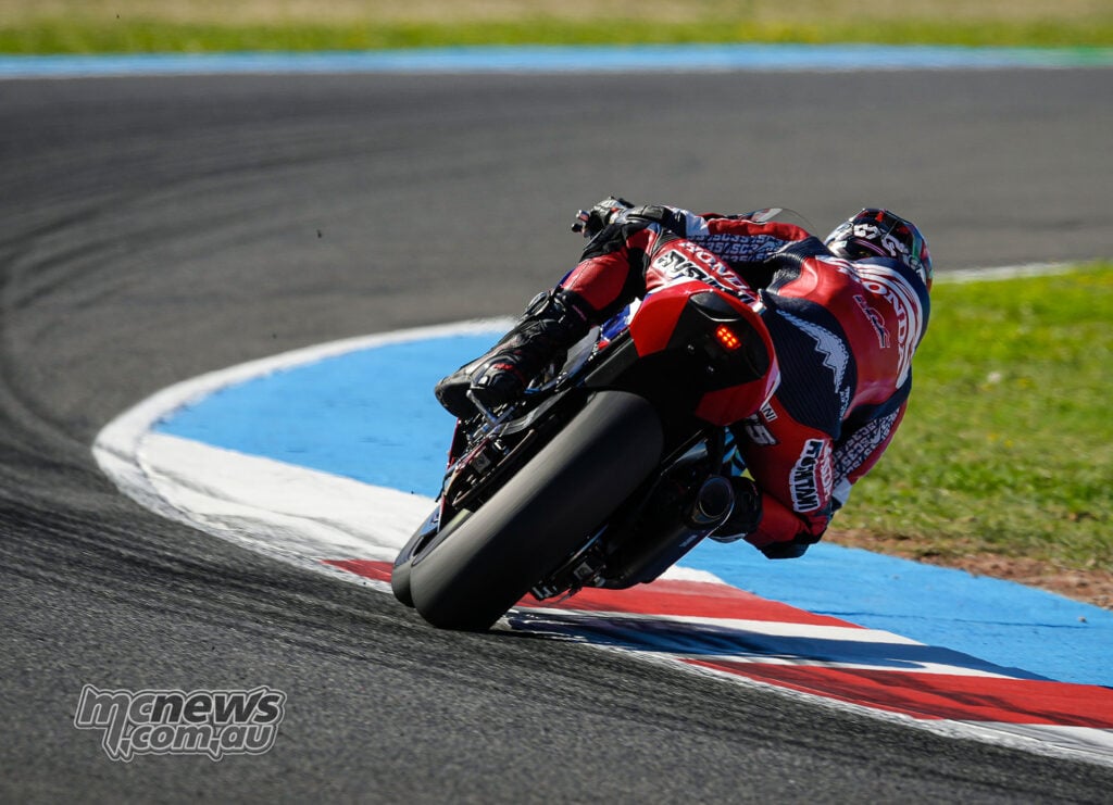 Rear three-quarter view of Somkiat Chantra leaning the number 35 Honda Fireblade over the painted kerb at Magny-Cours.