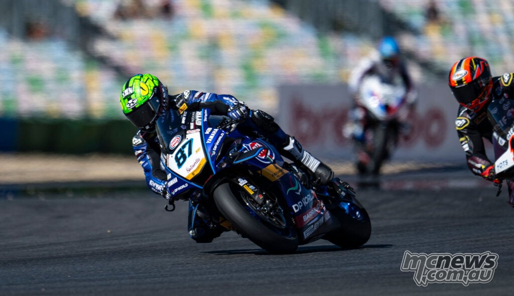 Remy Gardner leans the blue number 87 GYTR GRT Yamaha through a corner with another rider behind at Magny-Cours.