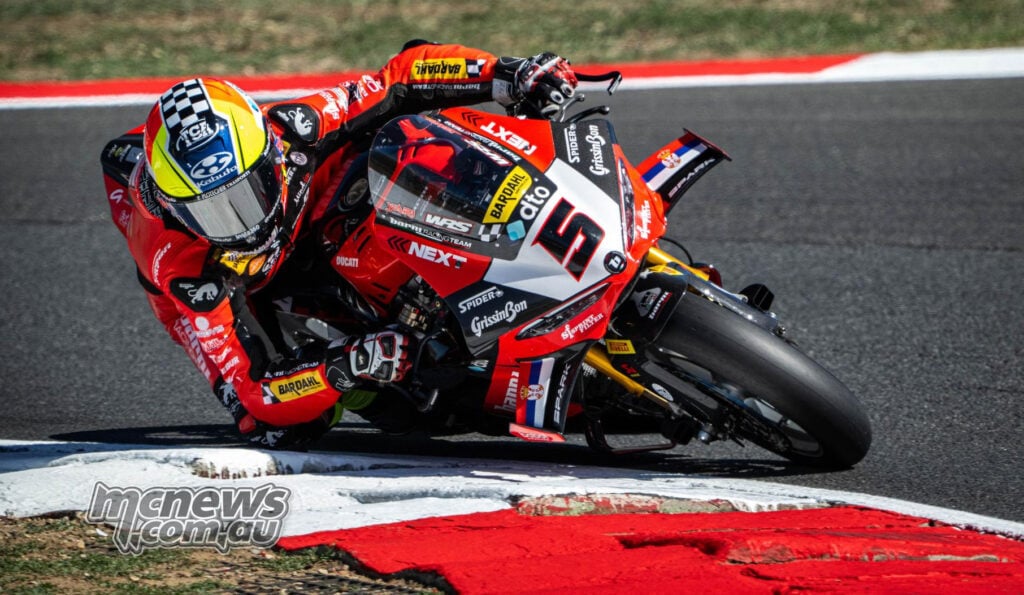 Yari Montella leans the red number 5 Barni Ducati across a kerb at Magny-Cours.