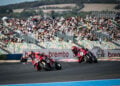 Nicolo Bulega on the number 11 Ducati leads team-mate Iker Lecuona past a packed grandstand at Magny-Cours.