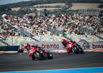 Nicolo Bulega on the number 11 Ducati leads team-mate Iker Lecuona past a packed grandstand at Magny-Cours.