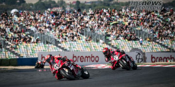 Nicolo Bulega on the number 11 Ducati leads team-mate Iker Lecuona past a packed grandstand at Magny-Cours.