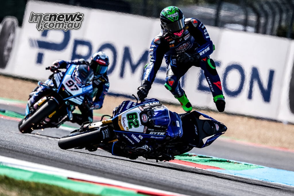 Stefano Manzi is airborne beside his fallen number 62 Yamaha as Jake Dixon rides past the incident.