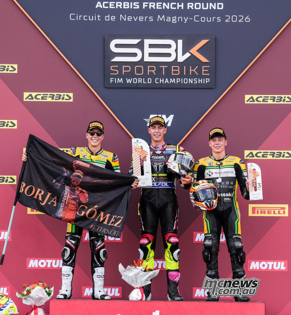Fenton Seabright stands on the centre podium step with winner’s trophy, flanked by David Salvador and Antonio Torres.