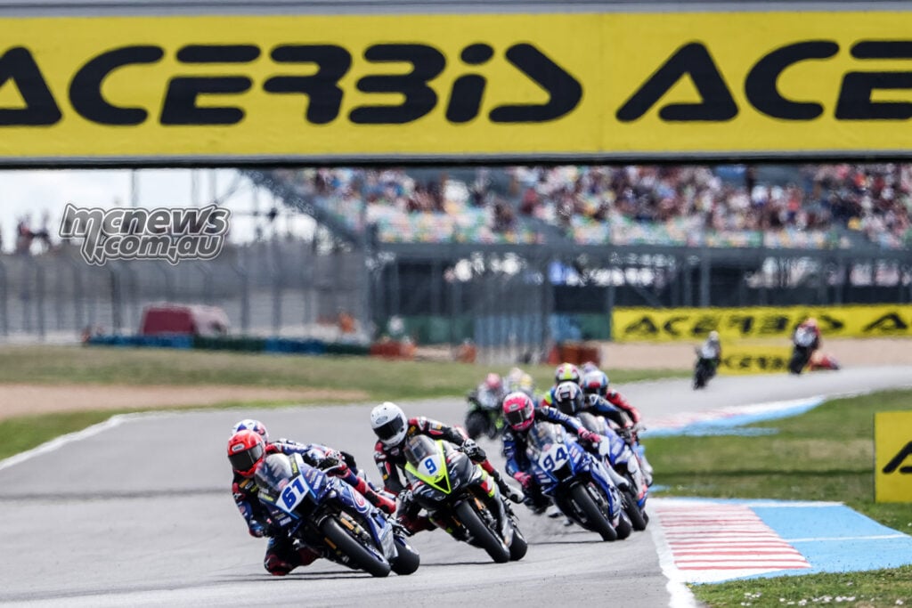 Can Oncu leads Jorge Navarro, Lucas Mahias and a line of WorldSSP riders beneath an Acerbis bridge at Magny-Cours.