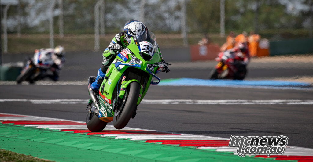 Garrett Gerloff lifts the front wheel of his green Kawasaki Ninja ZX-10RR over the Magny-Cours kerbing.