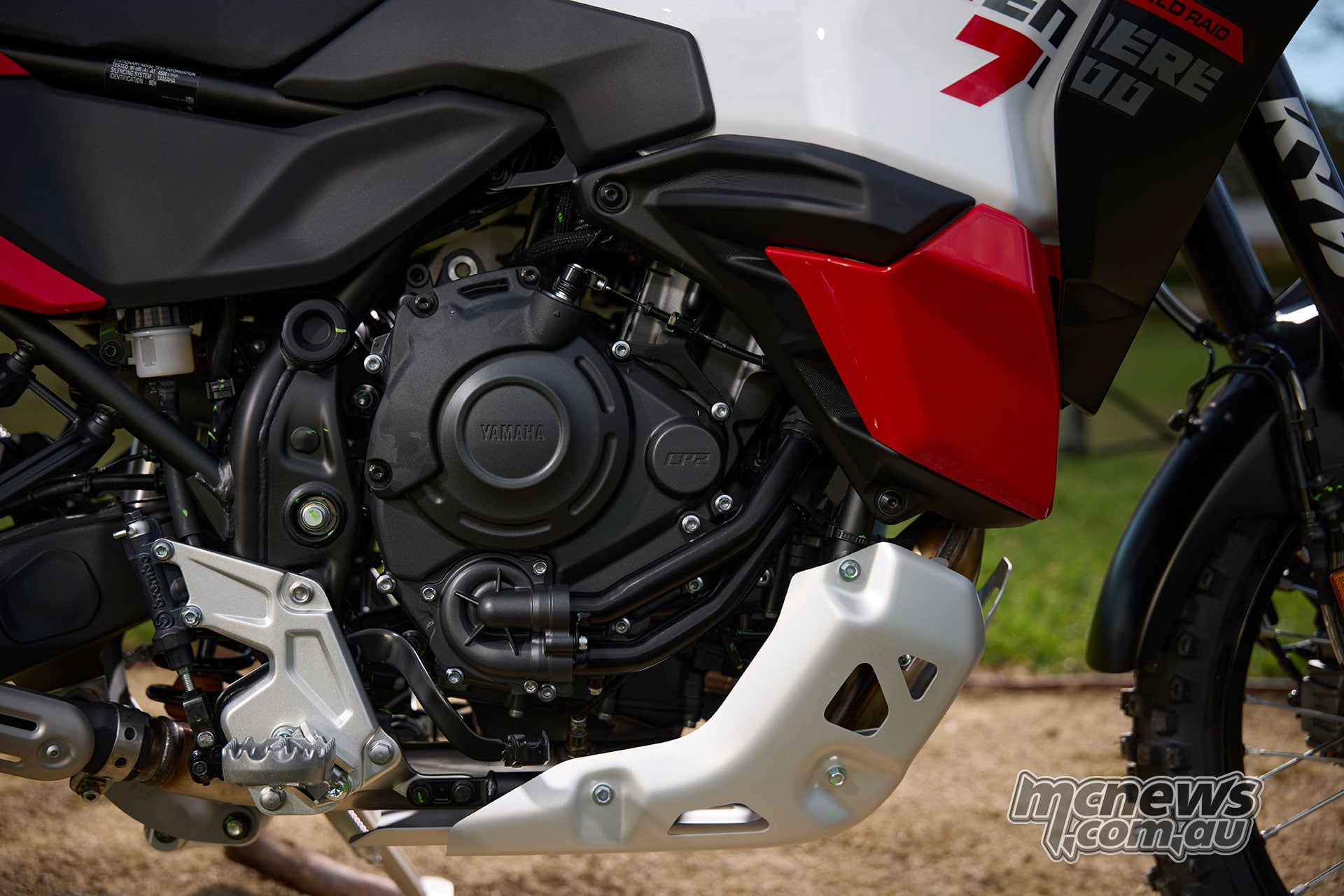 Right side of the World Raid’s CP2 engine, frame, footpeg and silver engine guard.