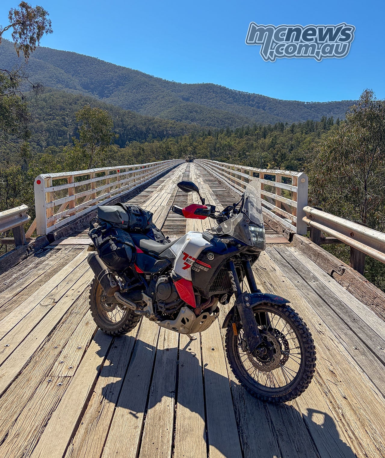 Luggage-equipped Yamaha Ténéré 700 World Raid parked on the timber deck of McKillops Bridge.