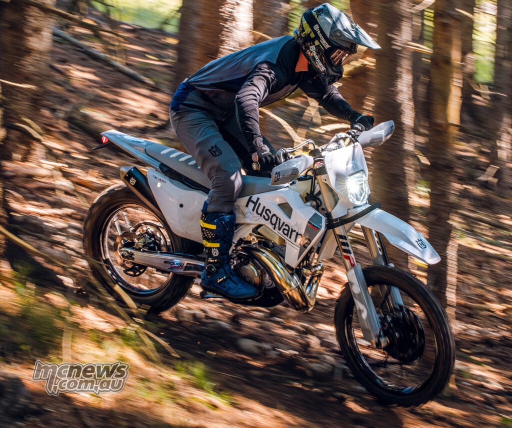 2027 Husqvarna TE 300 Pro two-stroke being ridden through technical forest terrain