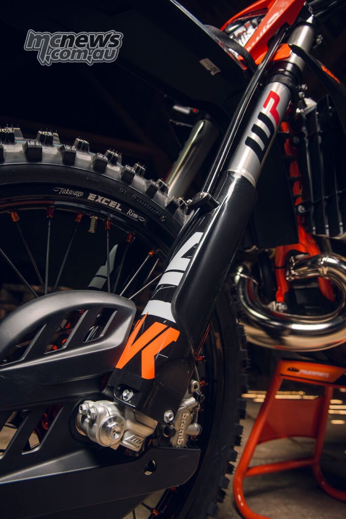 Close-up of the WP XACT fork, front brake-disc guard and Excel rim on the 2027 KTM 300 EXC HARDENDURO.