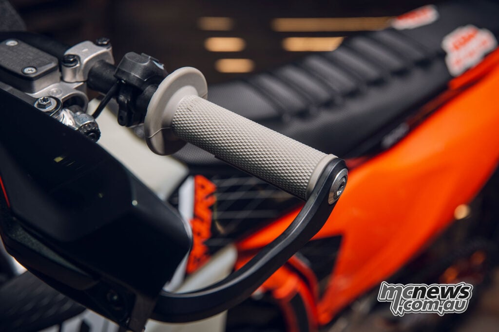 Close-up of a grey ODI grip and black wrap-around handguard on the 2027 KTM 300 EXC HARDENDURO.