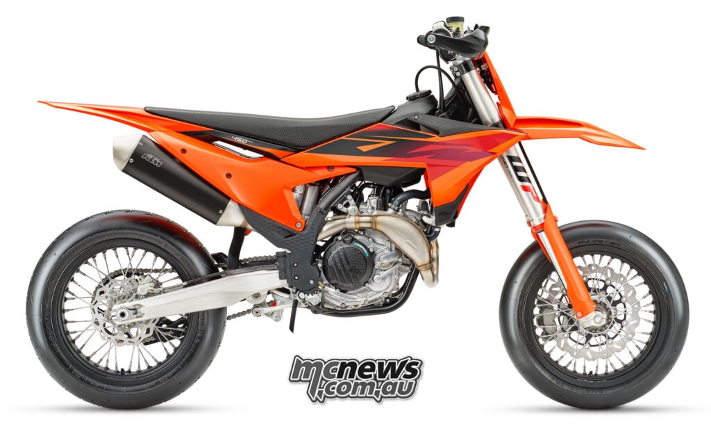 Right-side studio profile of the 2027 KTM 450 SMR with orange bodywork and black exhaust