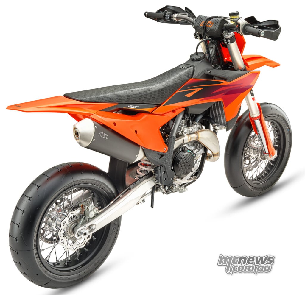 Rear three-quarter studio view of the 2027 KTM 450 SMR showing the rear slick tyre and exhaust