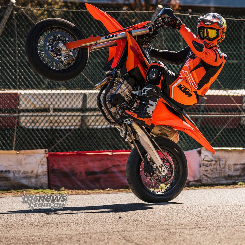 Rider performing a stoppie on the 2027 KTM 450 SMR with the rear wheel high in the air
