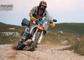 2027 KTM 690 Rally being ridden hard through a loose gravel corner