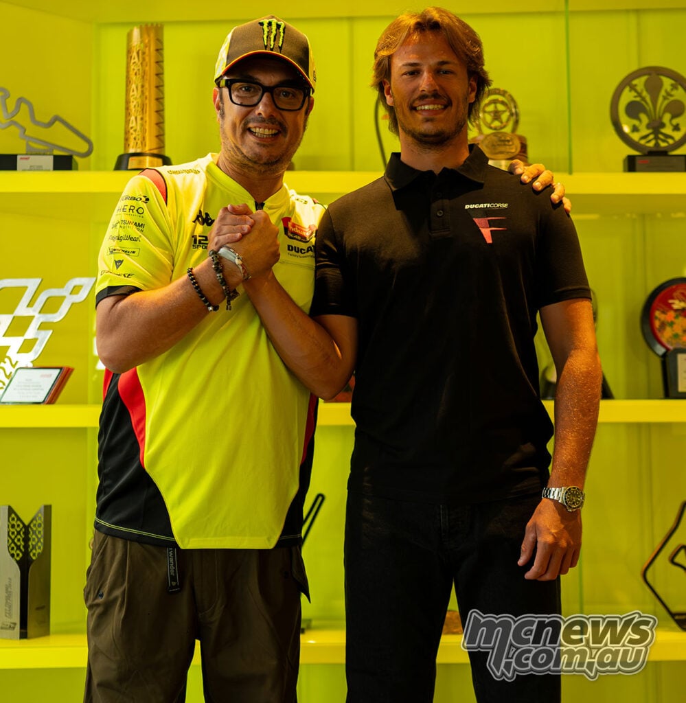 Alessio Salucci and Nicolò Bulega smile and clasp hands following confirmation of Bulega’s 2027 VR46 MotoGP deal.