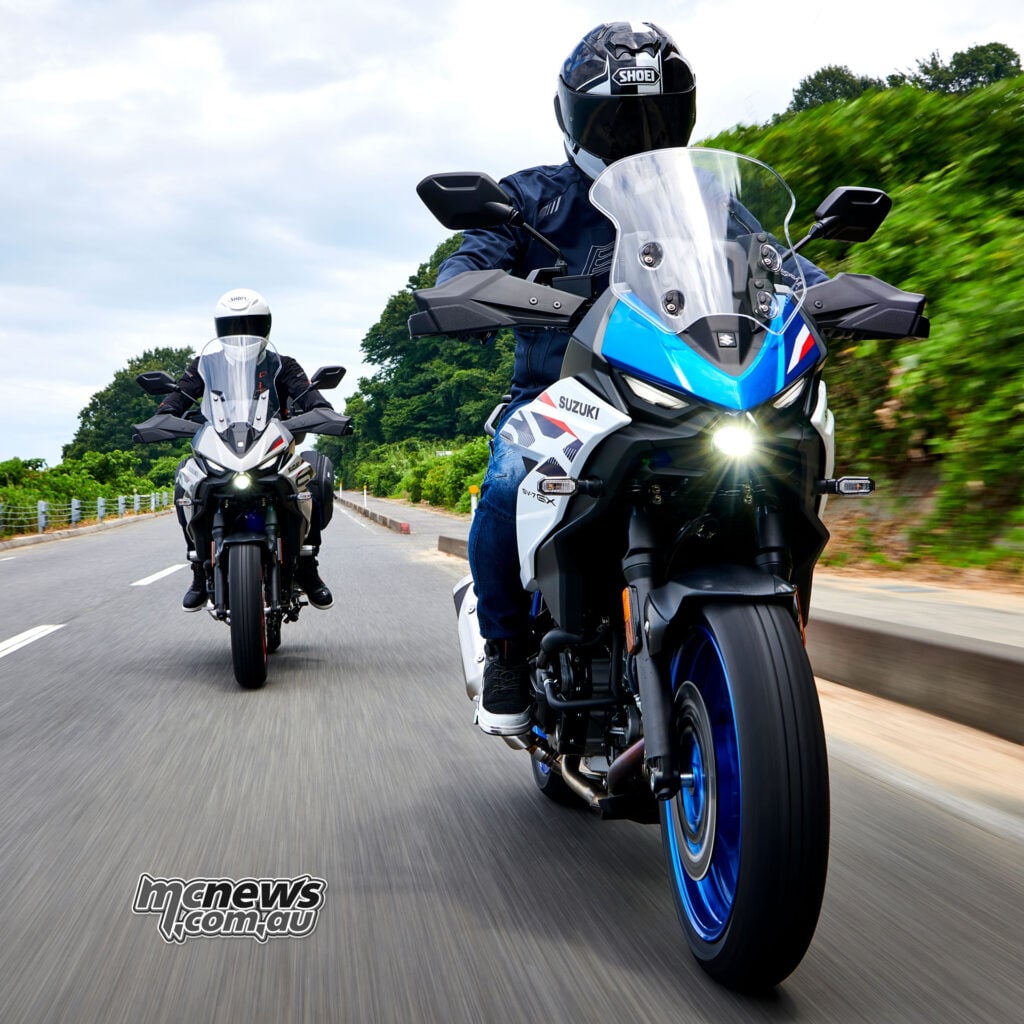 Front view of two Suzuki SV-7GX motorcycles riding with their LED headlights illuminated
