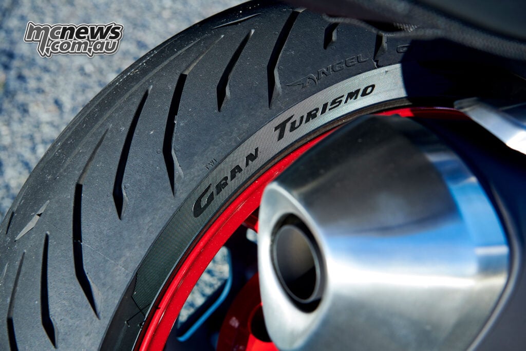 Close-up of a Pirelli Angel GT II rear tyre, red wheel rim and Suzuki SV-7GX exhaust outlet