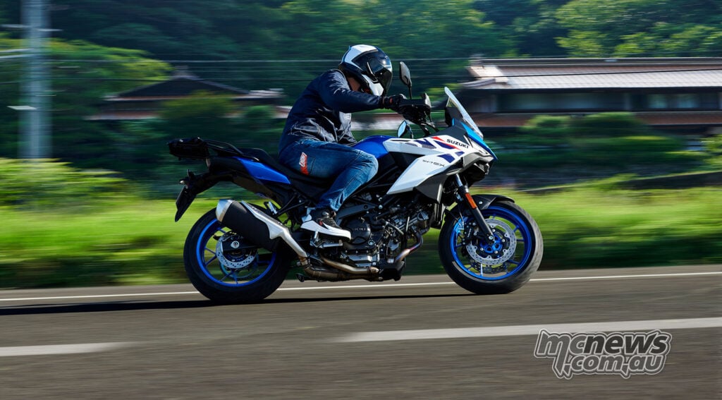 Blue and white Suzuki SV-7GX photographed side-on while being ridden on a sealed road