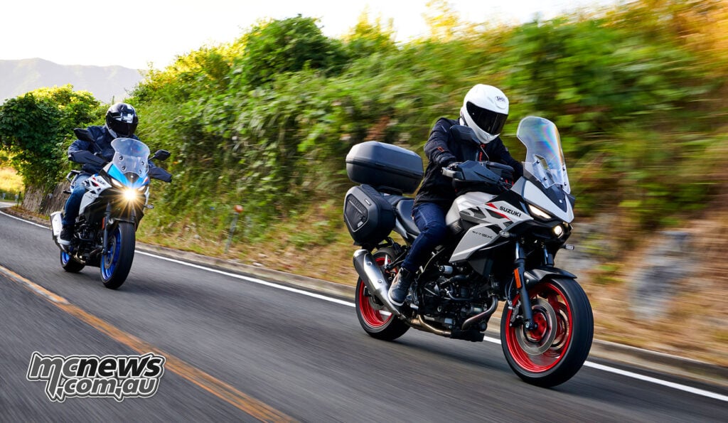 Pearl Matte Greige luggage-equipped Suzuki SV-7GX leading a blue and white SV-7GX on a country road