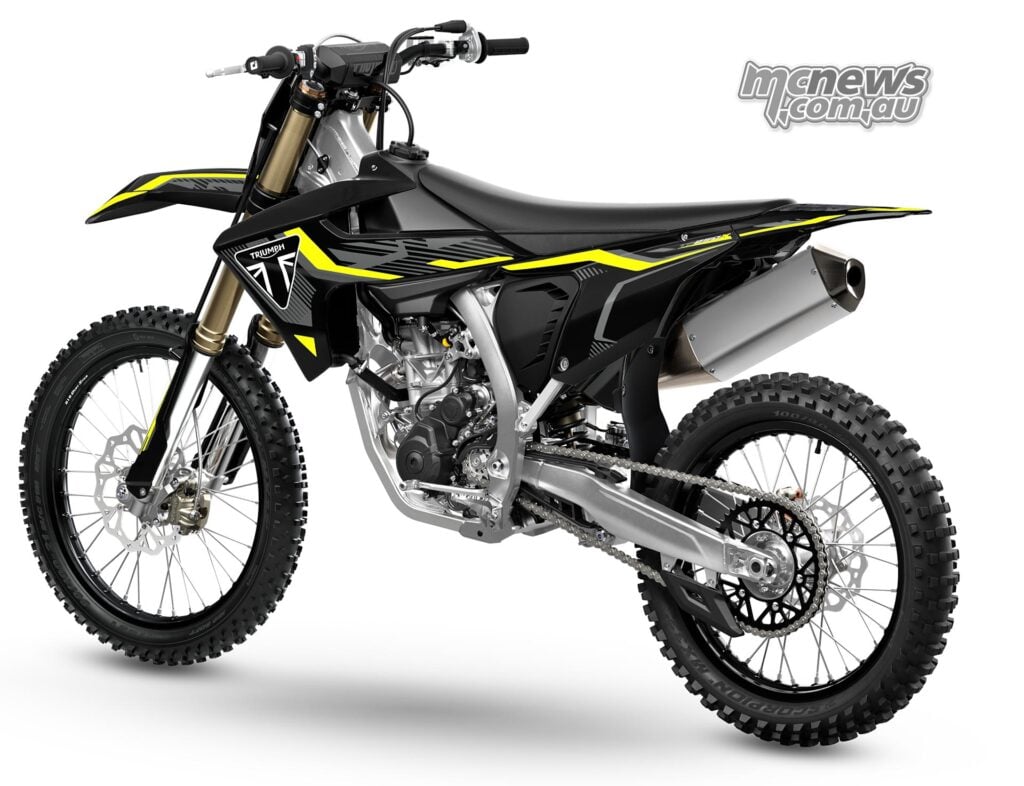 Rear left three-quarter view of the 2027 Triumph TF 250-X showing the drive chain, aluminium swingarm and black bodywork.