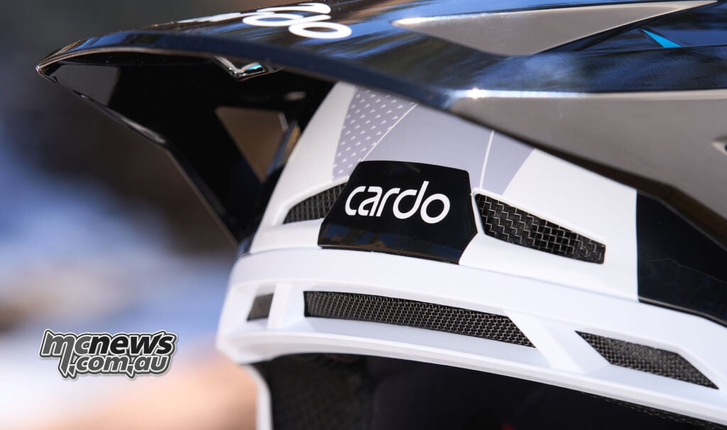 Close-up of the rear ventilation ports and Cardo logo beneath the peak of the Cardo Venture helmet.