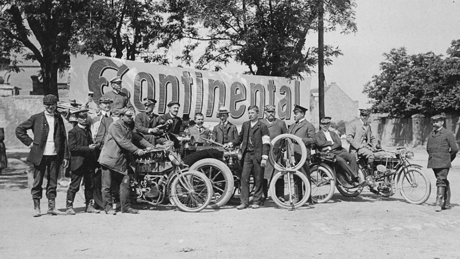Historic Continental photograph showing early motorcycles, tyres and company personnel