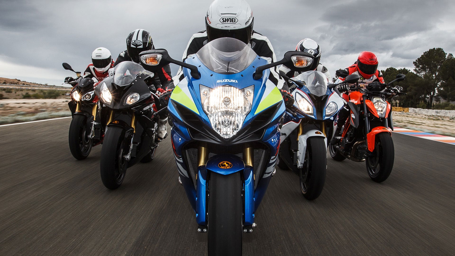 Group of sports motorcycles riding together on a racetrack on Continental tyres
