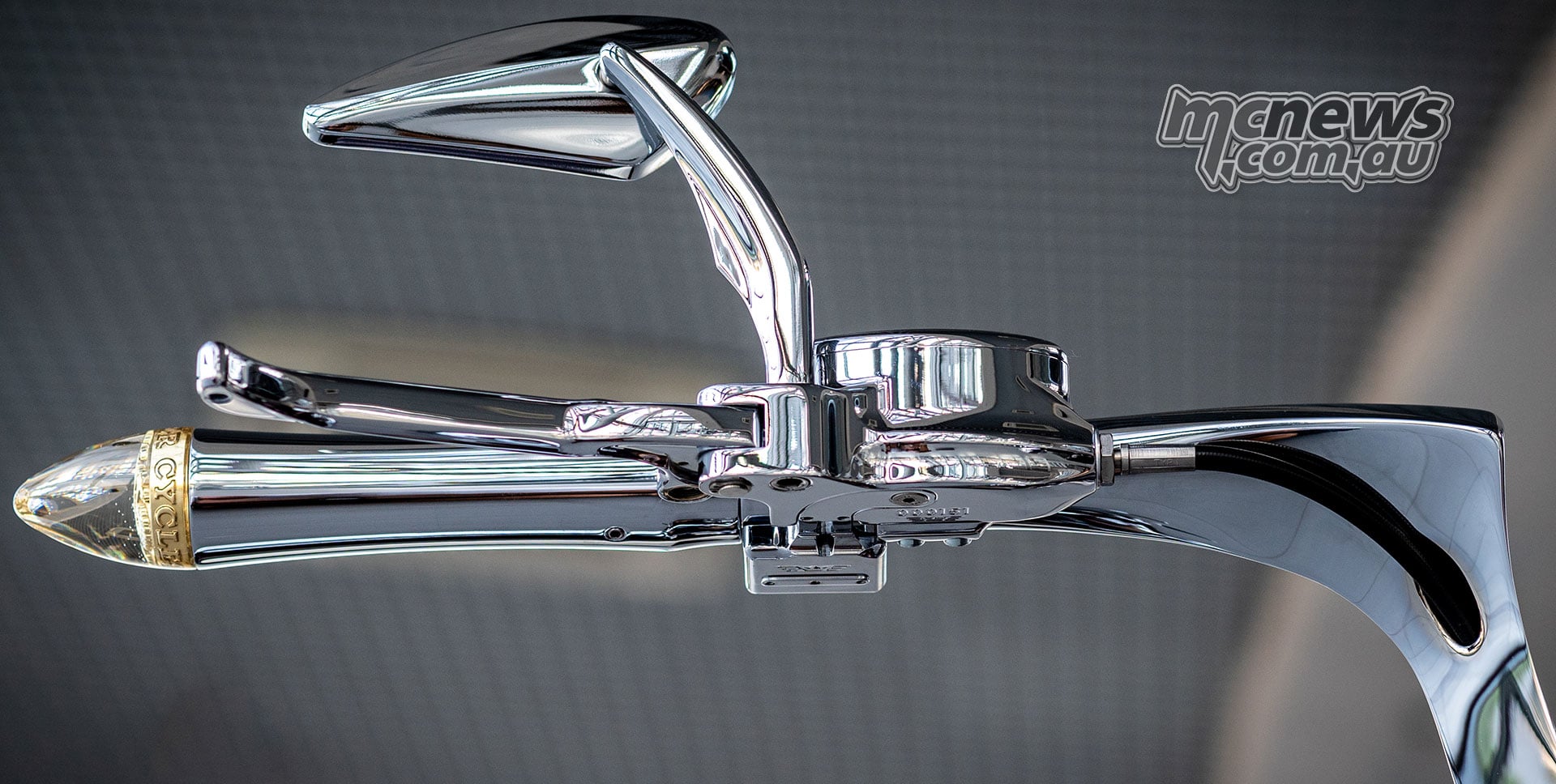 Close-up of Slow Burn’s sculpted chrome handlebar, grip, lever and mirror