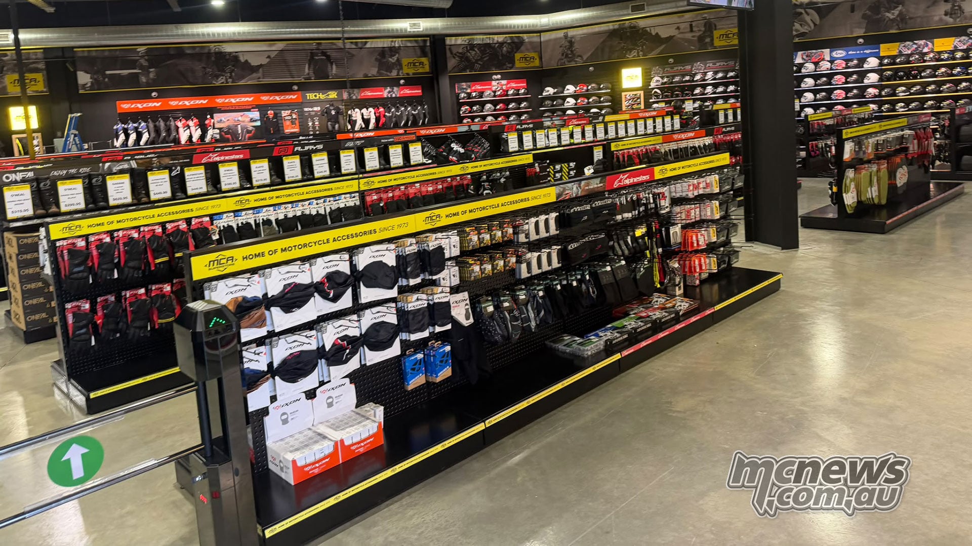 Gloves, packaged riding accessories and boots on display inside MCA Superstore Canberra.
