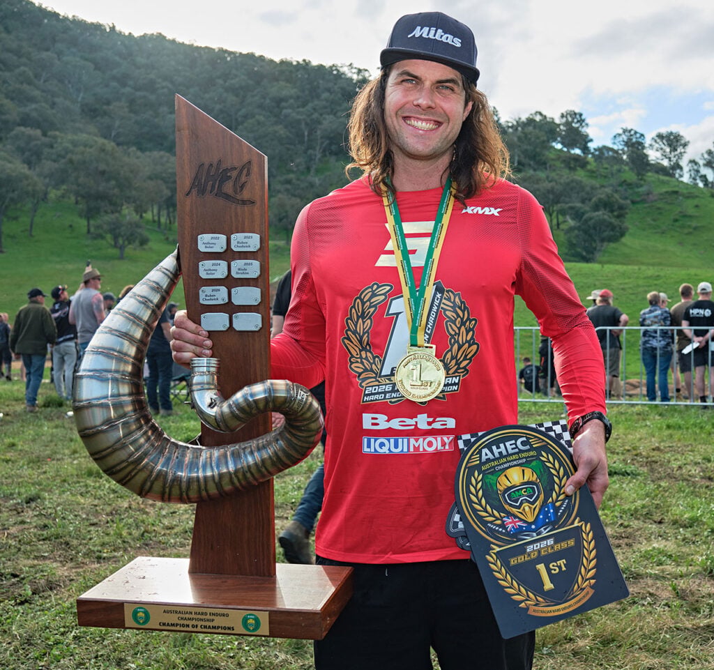 Ruben Chadwick celebrates winning the 2026 Australian Hard Enduro Championship Gold class title with the AHEC trophy and winner's plaque.