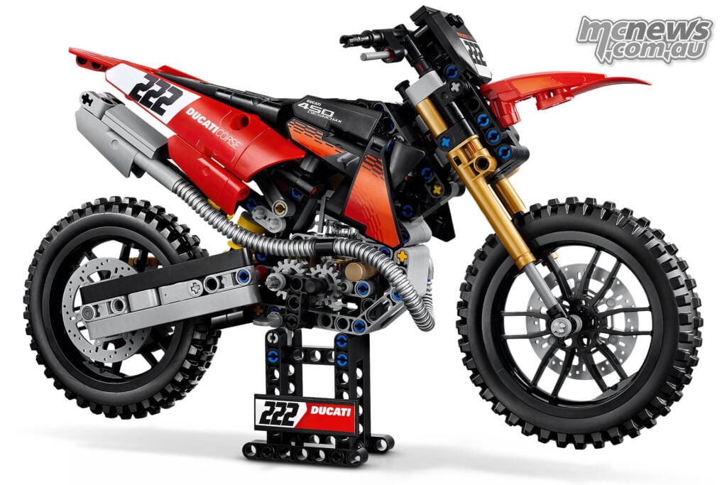 Right-side three-quarter view of the completed LEGO Ducati Desmo450 MX Factory on a black Ducati-branded display stand.