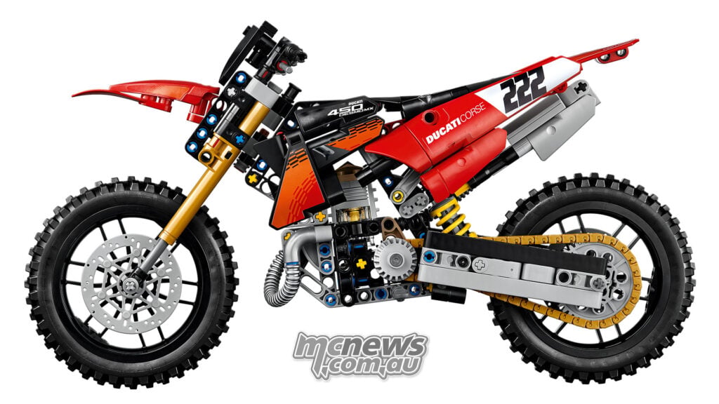 Left-side view of the LEGO Technic Ducati Desmo450 MX Factory with red bodywork, gold chain and number 222 plates.
