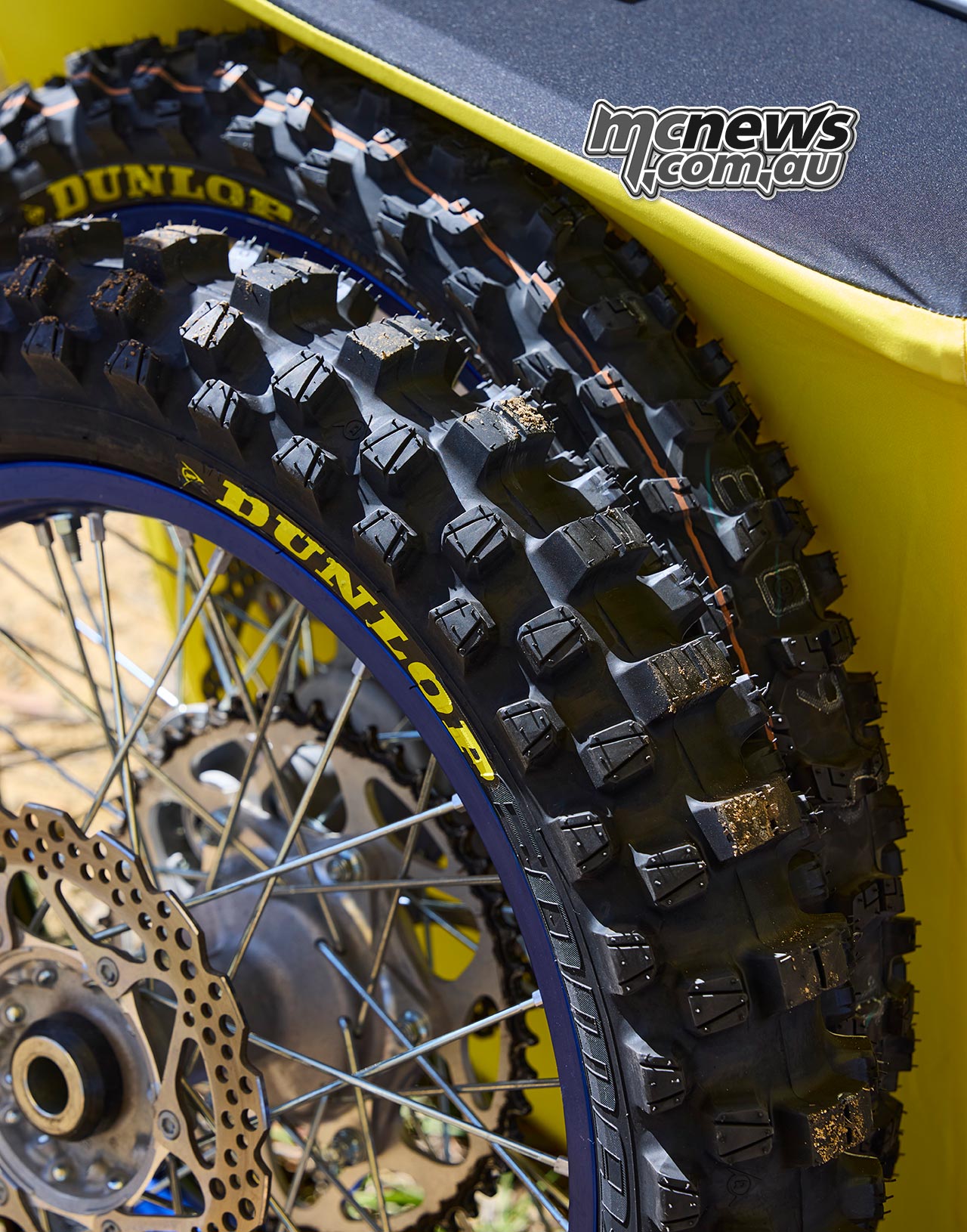Dunlop Geomax MX54 front and rear motocross tyres pictured together, showing the different tread profiles designed for steering and drive traction.