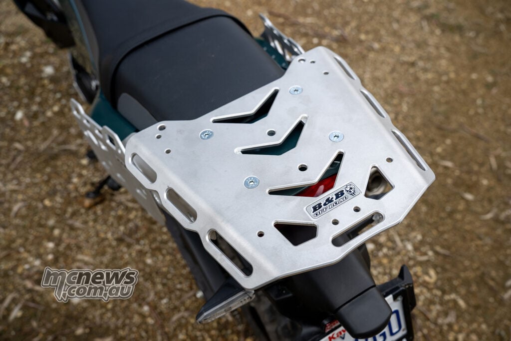 Top view of the B&B aluminium luggage plate on the Kawasaki KLE500 SE, showing its tie-down slots, mounting holes and logo.