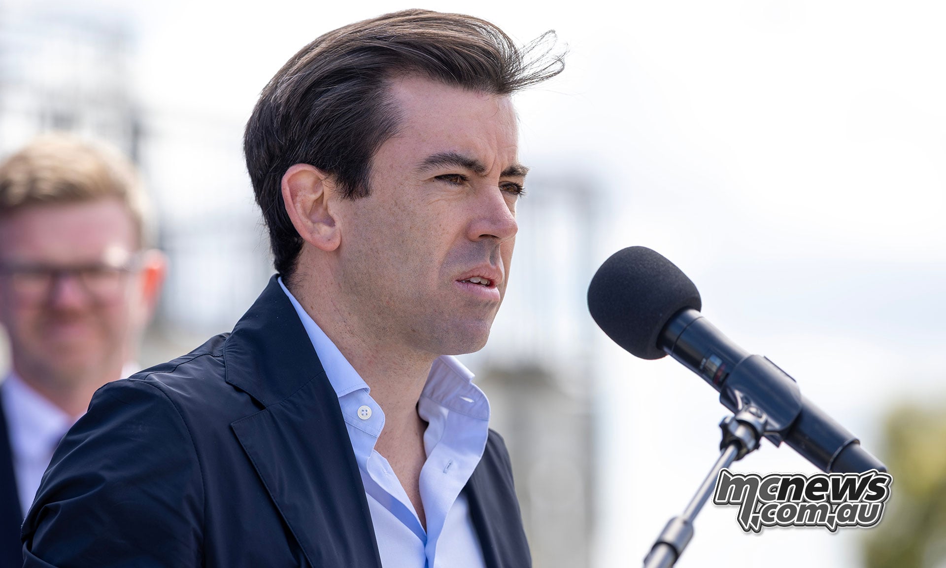 MotoGP Deputy CEO Carlos Ezpeleta speaks into a microphone at the Adelaide press conference